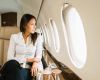 Woman private jet window