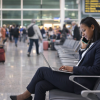 Woman at airport laptop phone